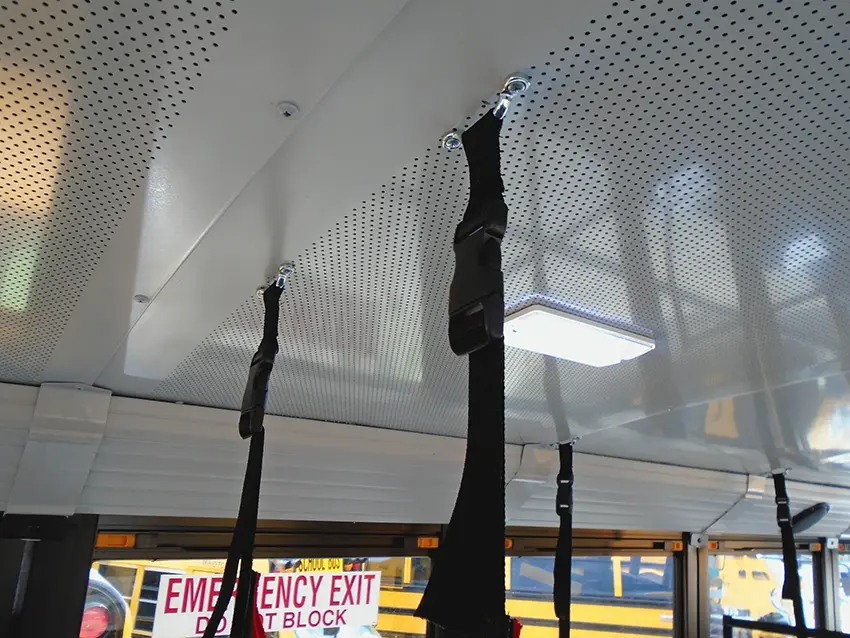 Clear soft barrier secured between bus seating positions