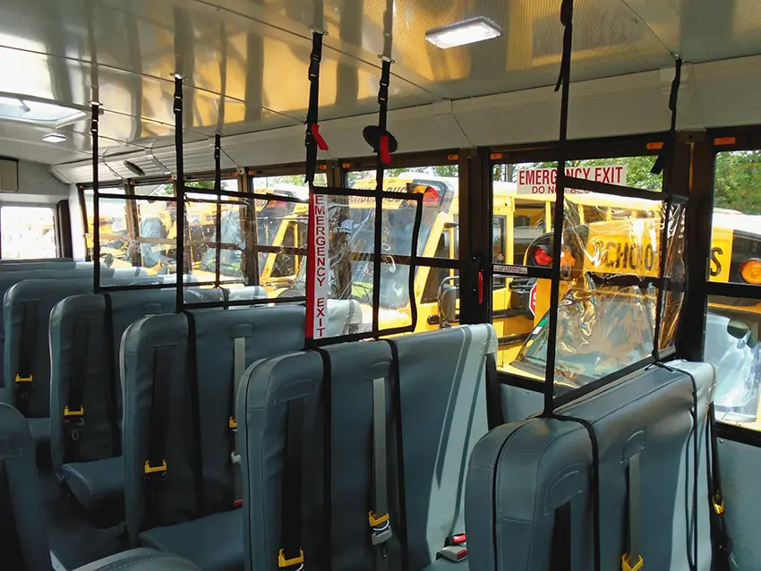 Soft barrier positioned in a school bus passenger area