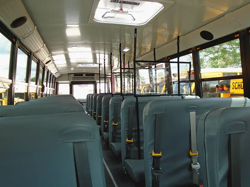 Installed bus seat barrier viewed from the aisle